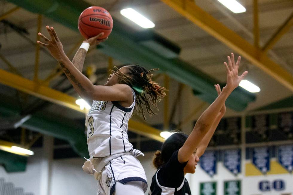 Spring Valley’s Aaliyah Gayles (3) shoots against Desert Oasis’ Lata Fakahufua (2 ...