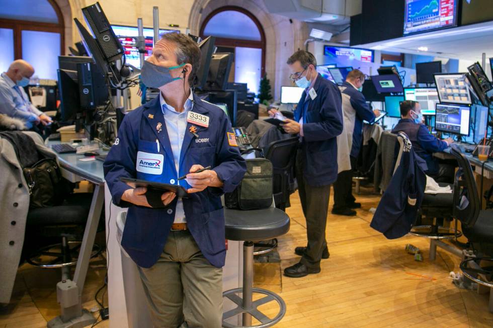 Traders work on the New York Stock Exchange floor in New York, Tuesday, Jan. 25, 2022. Stocks a ...