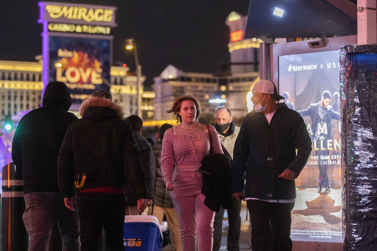 In this Dec. 31, 2021, file photo, ,New Year’s Eve crowds walk the Strip in Las Vegas.(Benjam ...