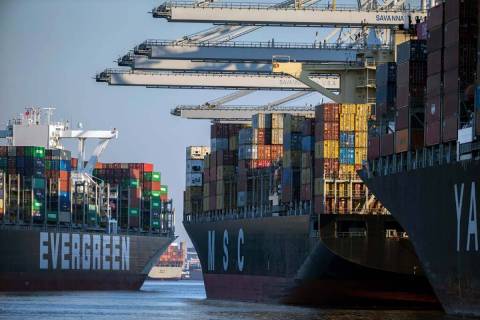 Container ship Ever Far, left, sails down river past the Georgia Ports Authority's Port of Sava ...
