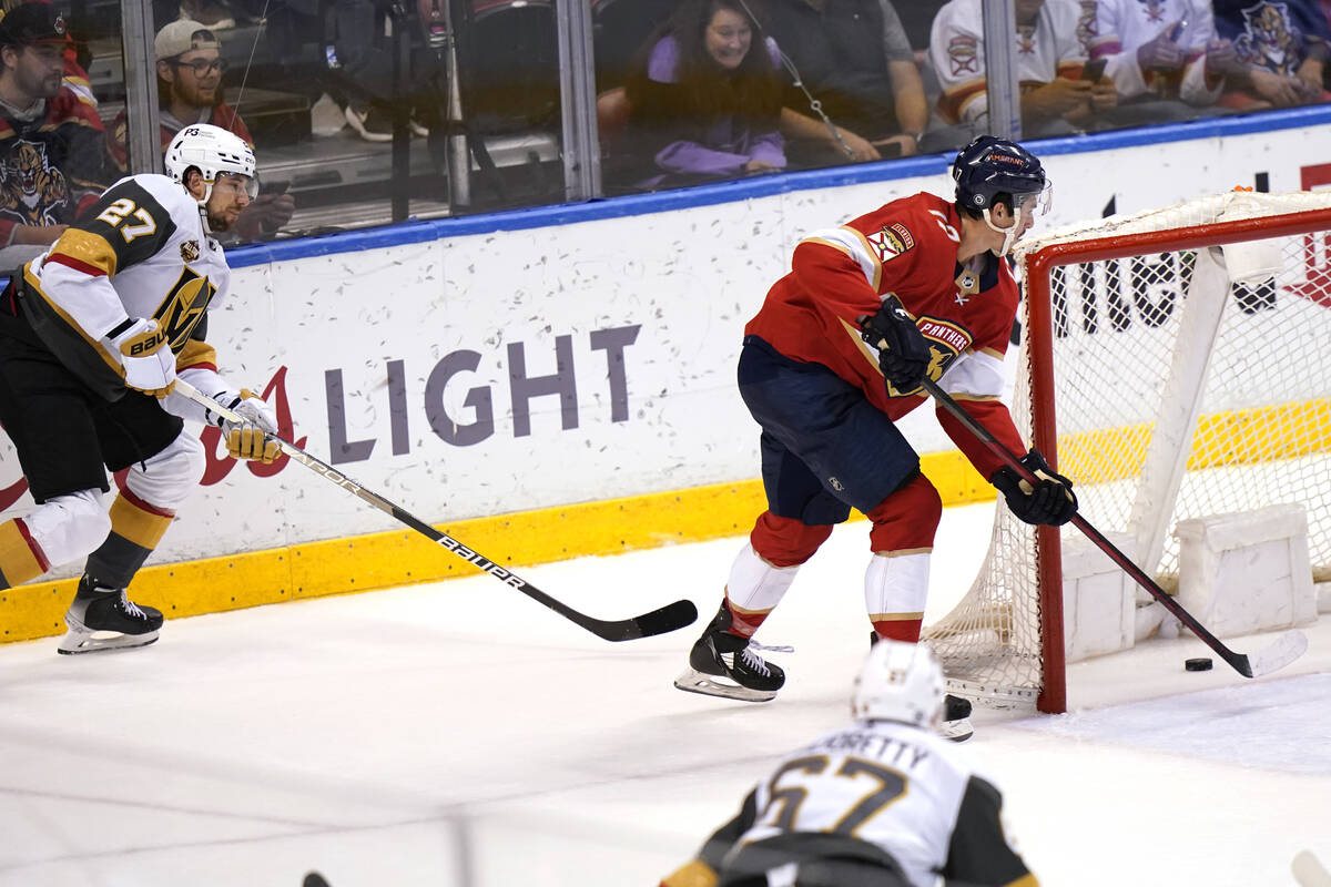 Florida Panthers left wing Mason Marchment, right, scores an empty net goal as Vegas Golden Kni ...