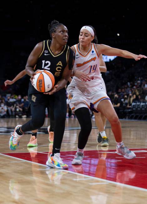 Las Vegas Aces guard Chelsea Gray (12) dribbles past Phoenix Mercury guard Bria Hartley (14) du ...