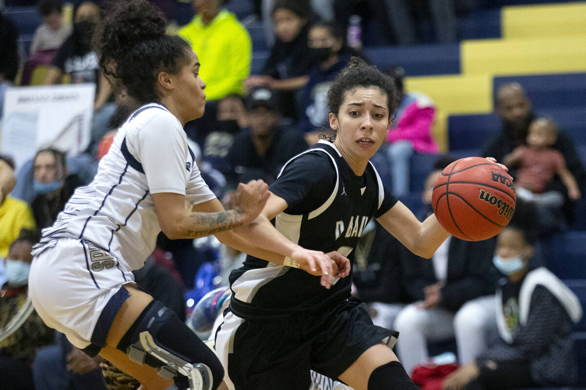 Desert Oasis’ Olivia Bigger (0) dribbles around Spring Valley’s Janiyah Davis (1) ...