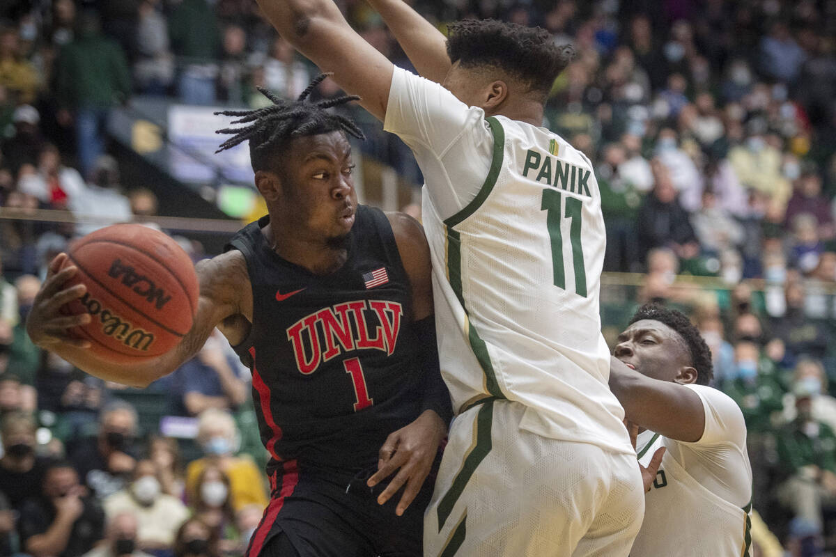 Colorado State forward Dischon Thomas (11) defends a pass under the basket by UNLV guard Michae ...