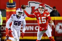 Kansas City Chiefs quarterback Patrick Mahomes (15) throws a pass as Buffalo Bills defensive en ...