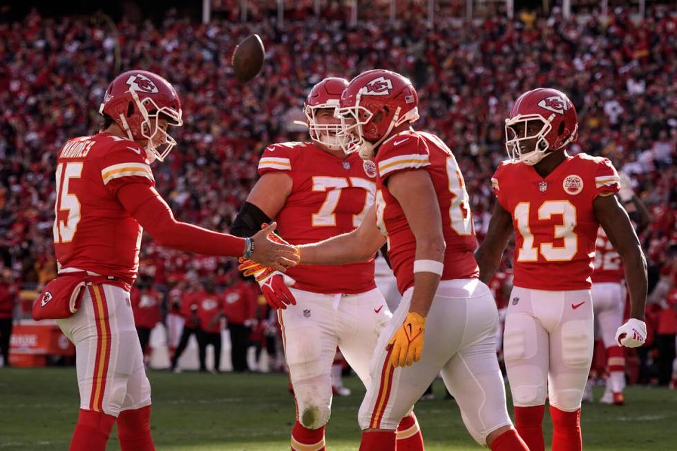 Kansas City Chiefs tight end Travis Kelce (87) celebrates with teammate Patrick Mahomes, left, ...