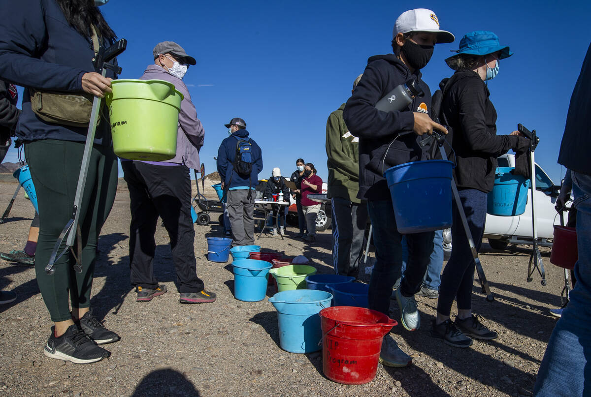 Volunteers grab buckets, trash bags and pickers as Evolution Expeditions and Get Outdoors Nevad ...