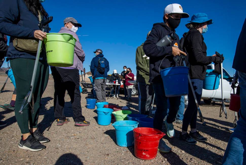 Volunteers grab buckets, trash bags and pickers as Evolution Expeditions and Get Outdoors Nevad ...