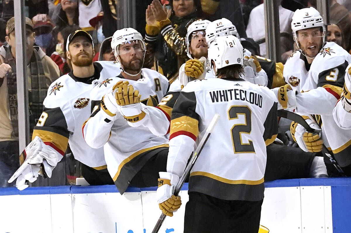 Vegas Golden Knights defenseman Zach Whitecloud (2) is congratulated after scoring a goal again ...