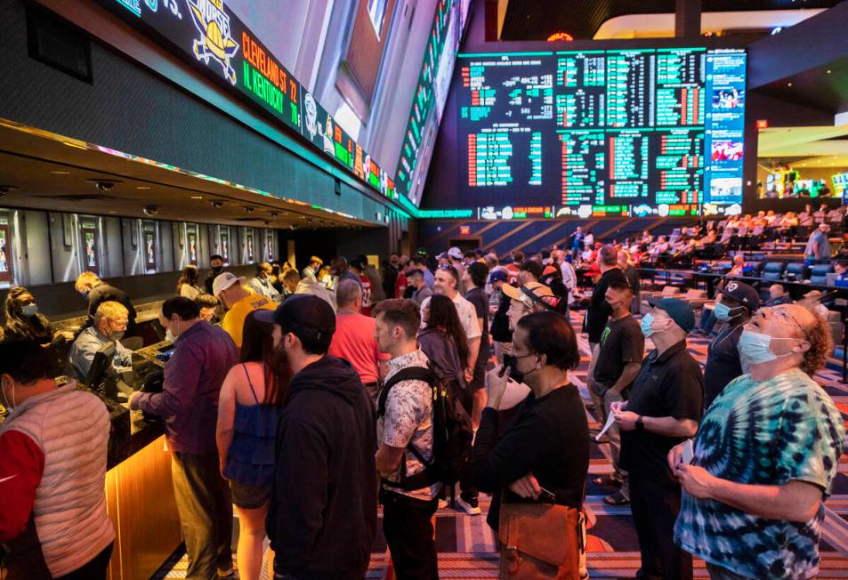 People hurry to place their bets before the start of the NFC Championship NFL football game bet ...