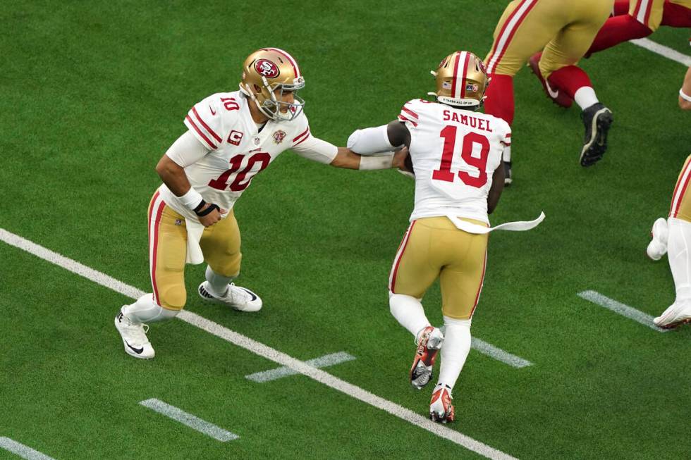 San Francisco 49ers quarterback Jimmy Garoppolo (10) hands the ball off to wide receiver Deebo ...