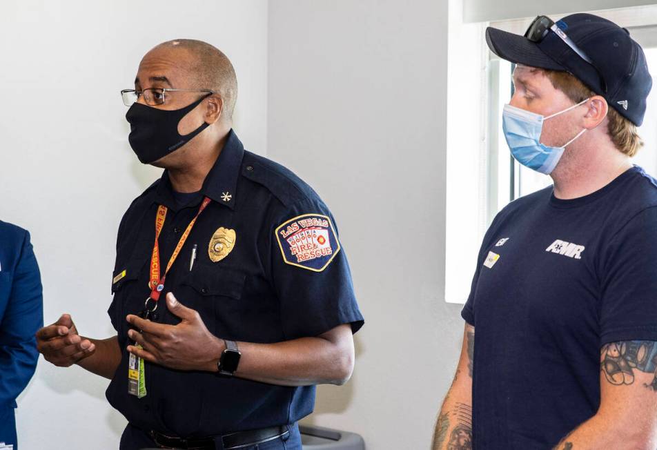 Jon Stevenson II, left, assistant fire chief for the Las Vegas Fire Department, speaks as Shawn ...