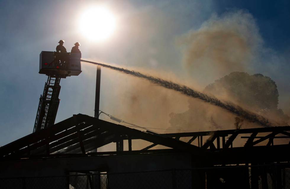 Las Vegas firefighters respond to the scene of a vacant building on fire at Maryland Parkway an ...