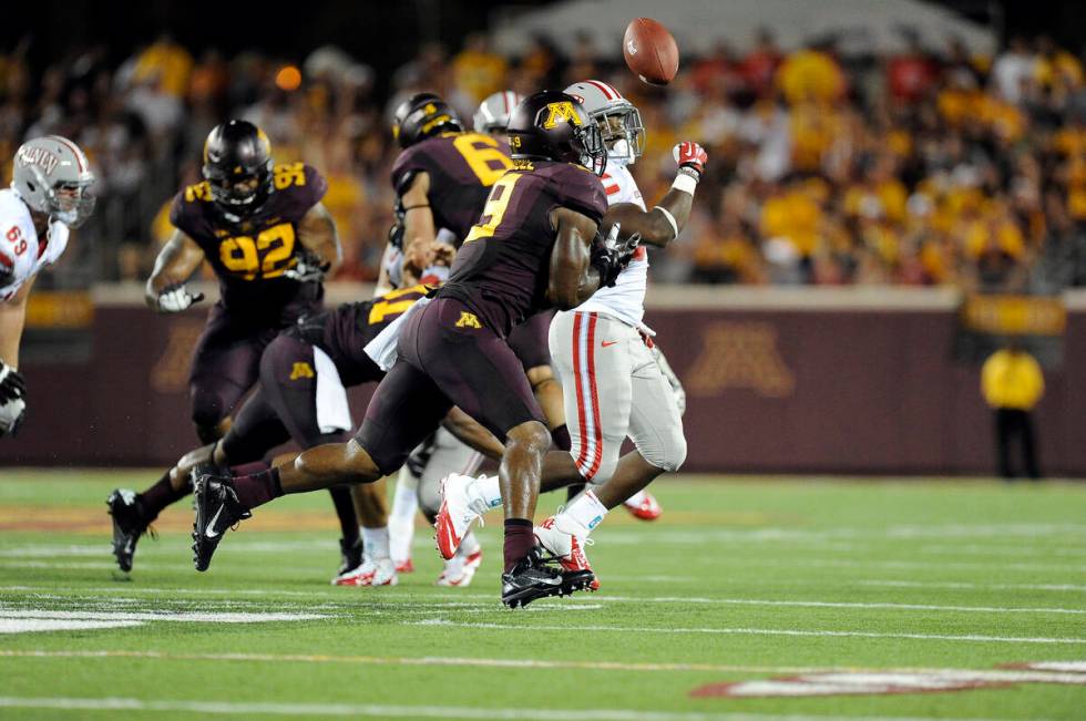 Minnesota linebacker James Manuel breaks up a pass intended for UNLV running back Shaquille Mur ...