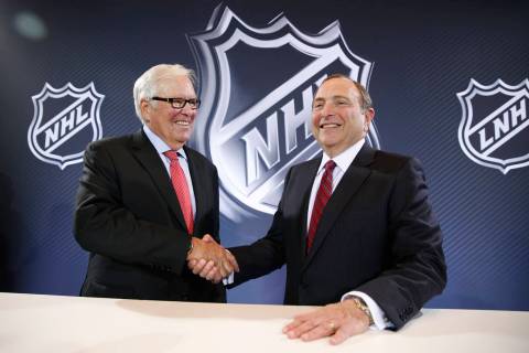 NHL Commissioner Gary Bettman, right, and Bill Foley pose for photographers during a news confe ...