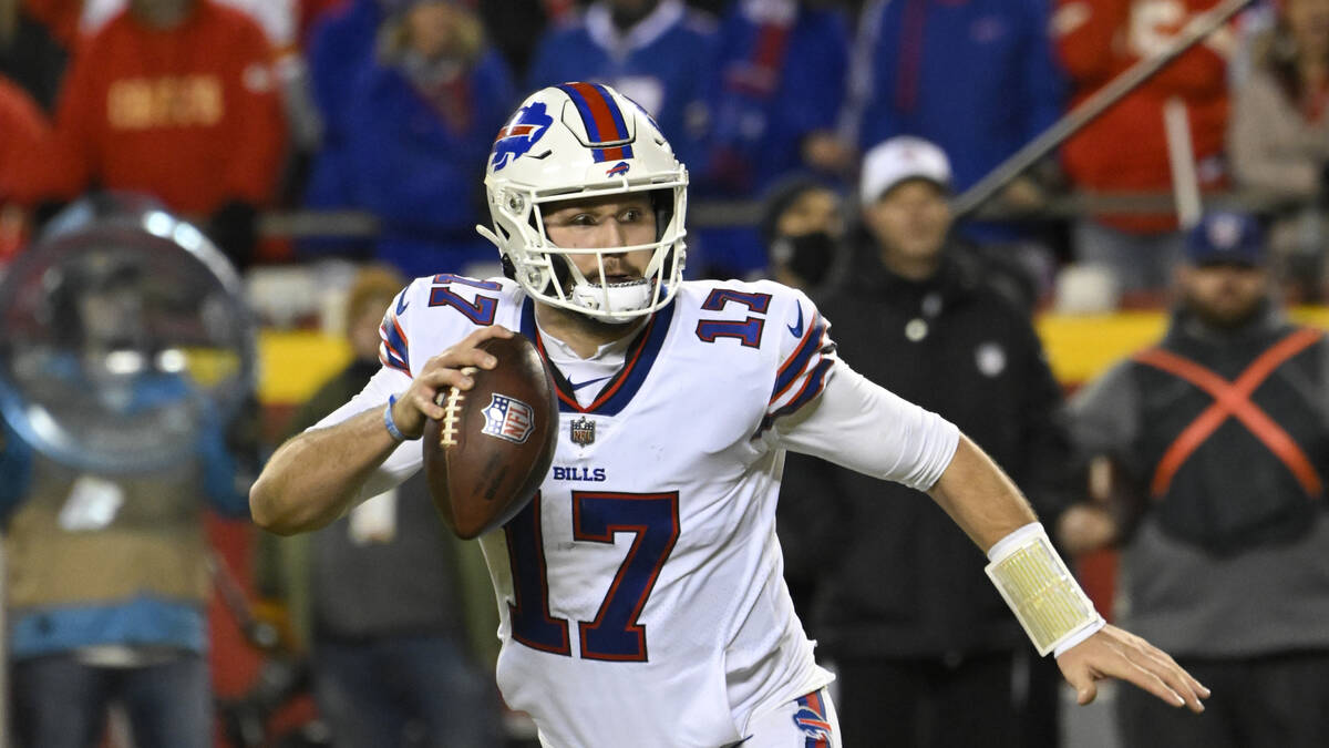 Buffalo Bills quarterback Josh Allen scrambles away from pressure before throwing for a two-poi ...