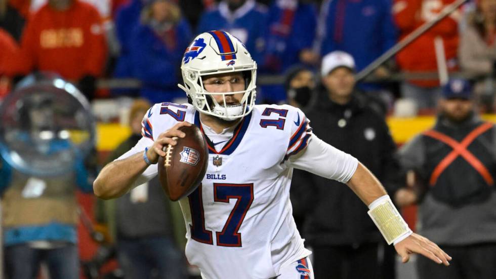 Buffalo Bills quarterback Josh Allen scrambles away from pressure before throwing for a two-poi ...