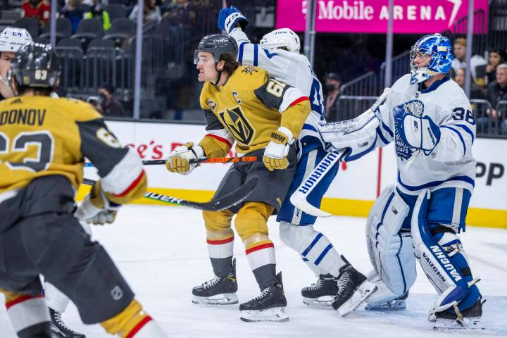 Golden Knights right wing Mark Stone (61) fights for position near the net with Toronto Maple L ...