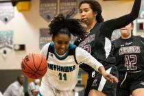 Silverado High's Ashley Saxton (11) drives past Faith Lutheran High's Ariel Thomas (22) during ...