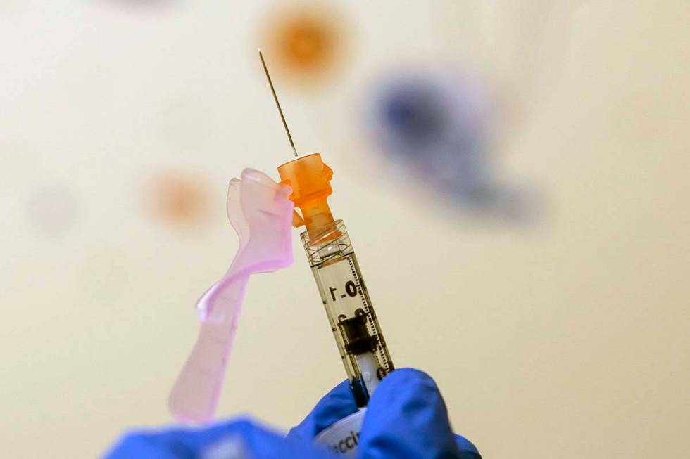 Nurse Lydia Holly prepares a child's COVID-19 vaccine dose, on Nov. 3, 2021, at Children's Nati ...