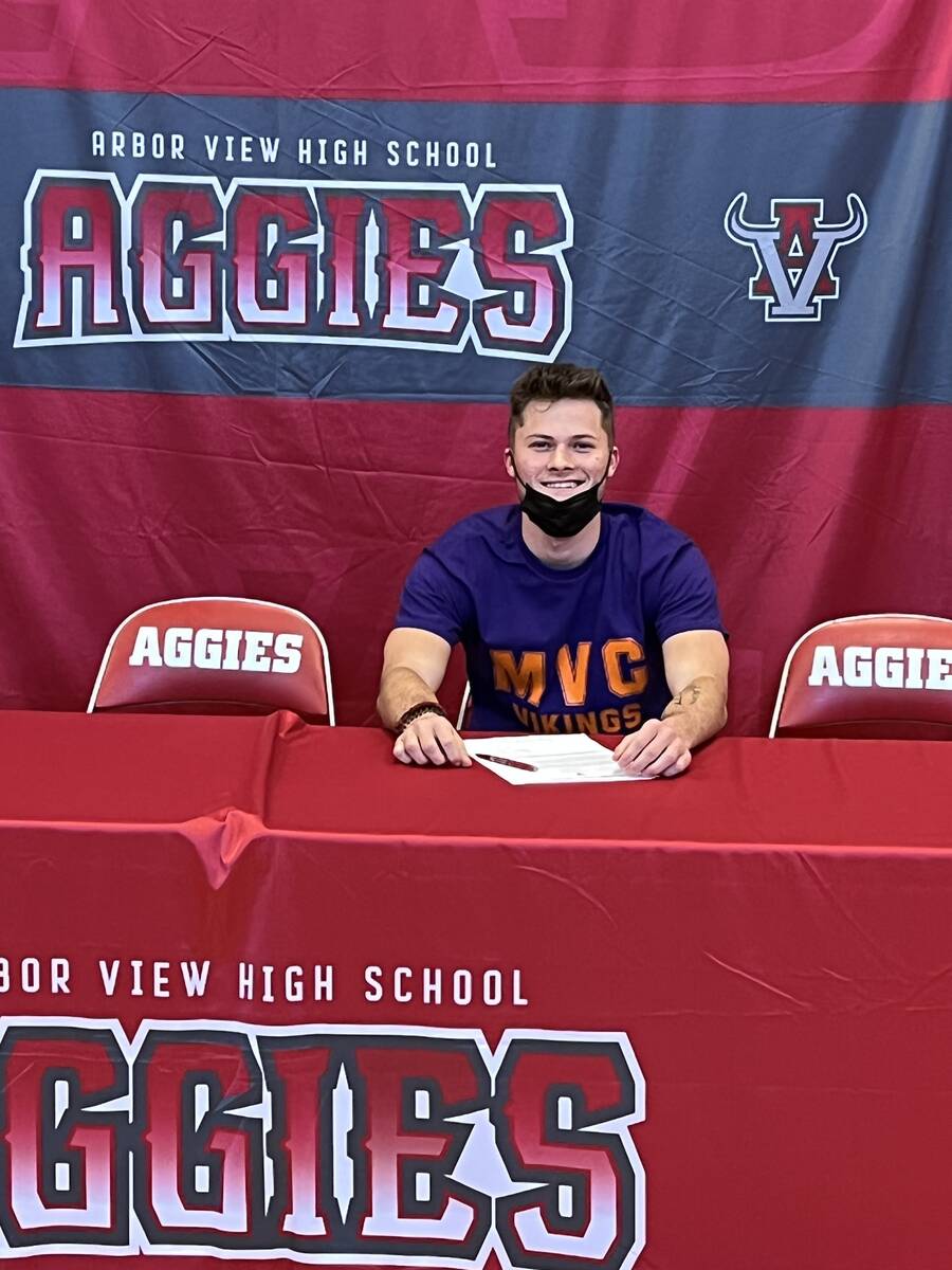 Arbor View quarterback Kyle Holmes signs to play football at Missouri Valley College on Wednesd ...