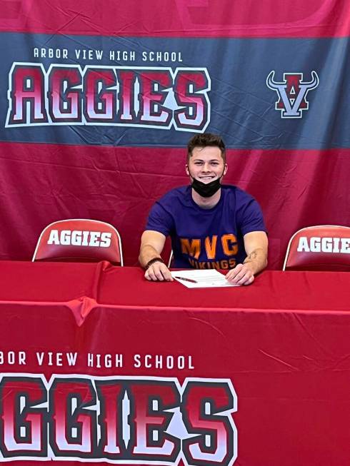 Arbor View quarterback Kyle Holmes signs to play football at Missouri Valley College on Wednesd ...