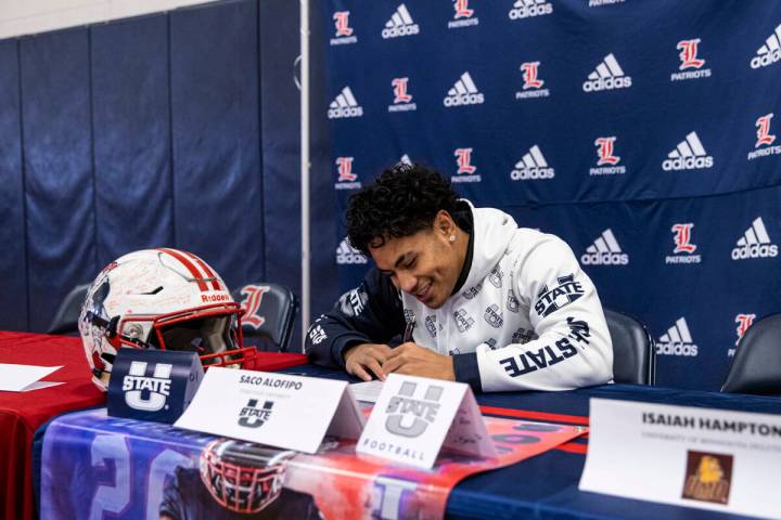 Liberty’s Saco Alofipo signs a letter of intent to play football at Utah State Universit ...