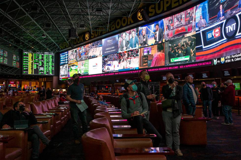 Bettors eye the board as Super Bowl prop bets are released at the Westgate SuperBook on Thursda ...