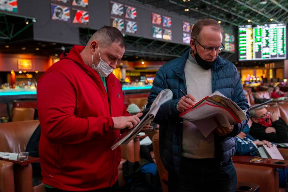 Jason Cee, of Florida, left, and Ken Fowler, of California, wait in line to place Super Bowl pr ...