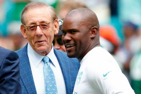 FILE -Miami Dolphins head coach Brian Flores talks to Miami Dolphins owner Stephen M. Ross duri ...