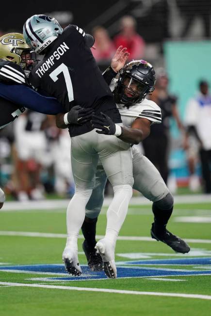 East linebacker Big Kat Bryant, of UCF, (5) tackles West quarterback Skylar Thompson, of Kansas ...