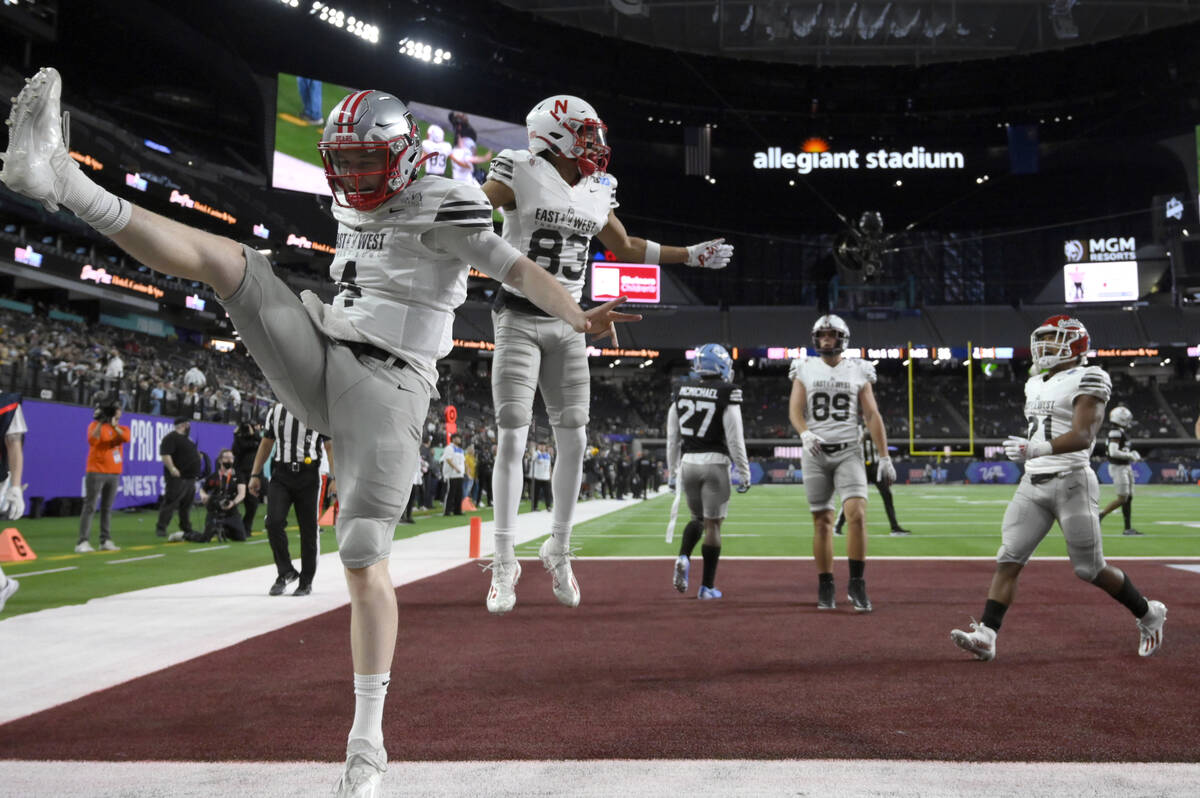 East quarterback EJ Perry (4), of Brown, celebrates with wide receiver Samori Toure (83), of Ne ...