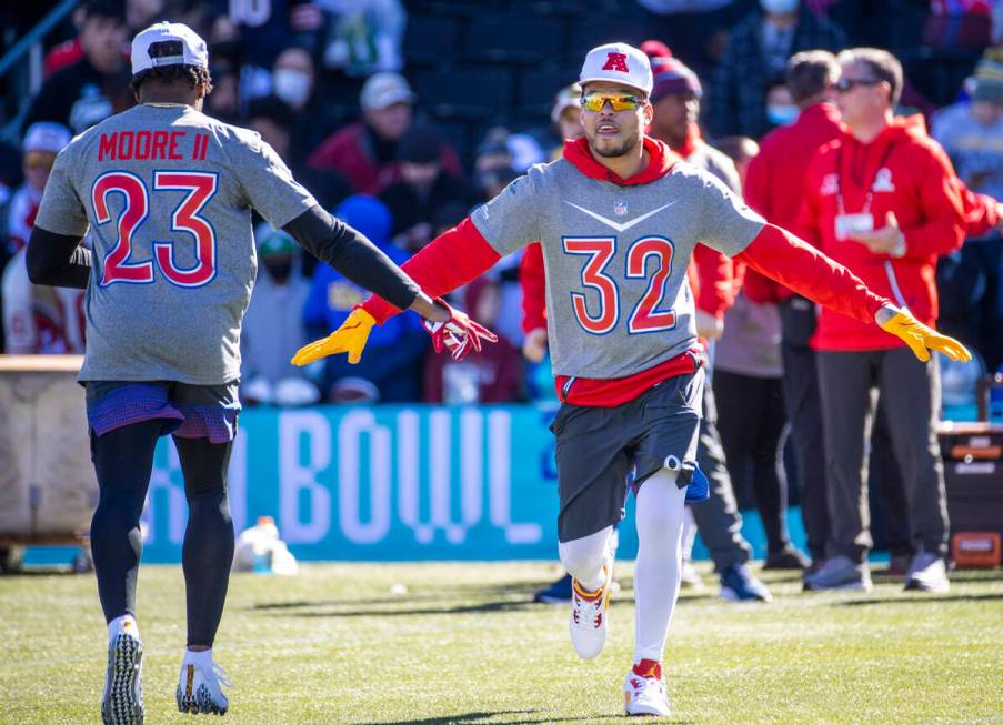 Kansas City Chiefs Tyrann Mathieu (32) greets teammate Indianapolis Colts Kenny Moore II (23) w ...