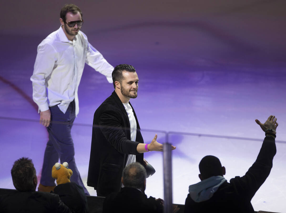 Raiders players Derek Carr, middle, and Hunter Renfrow make an appearance during the NHL All-St ...