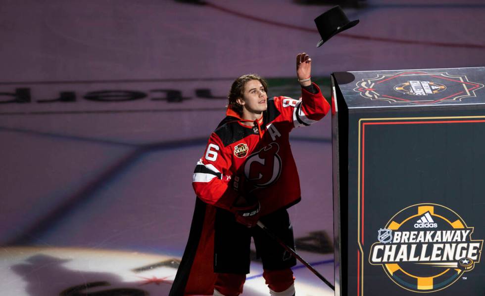 New Jersey Devils center Jack Hughes (86) performs a magic trick during the NHL All-Star skills ...