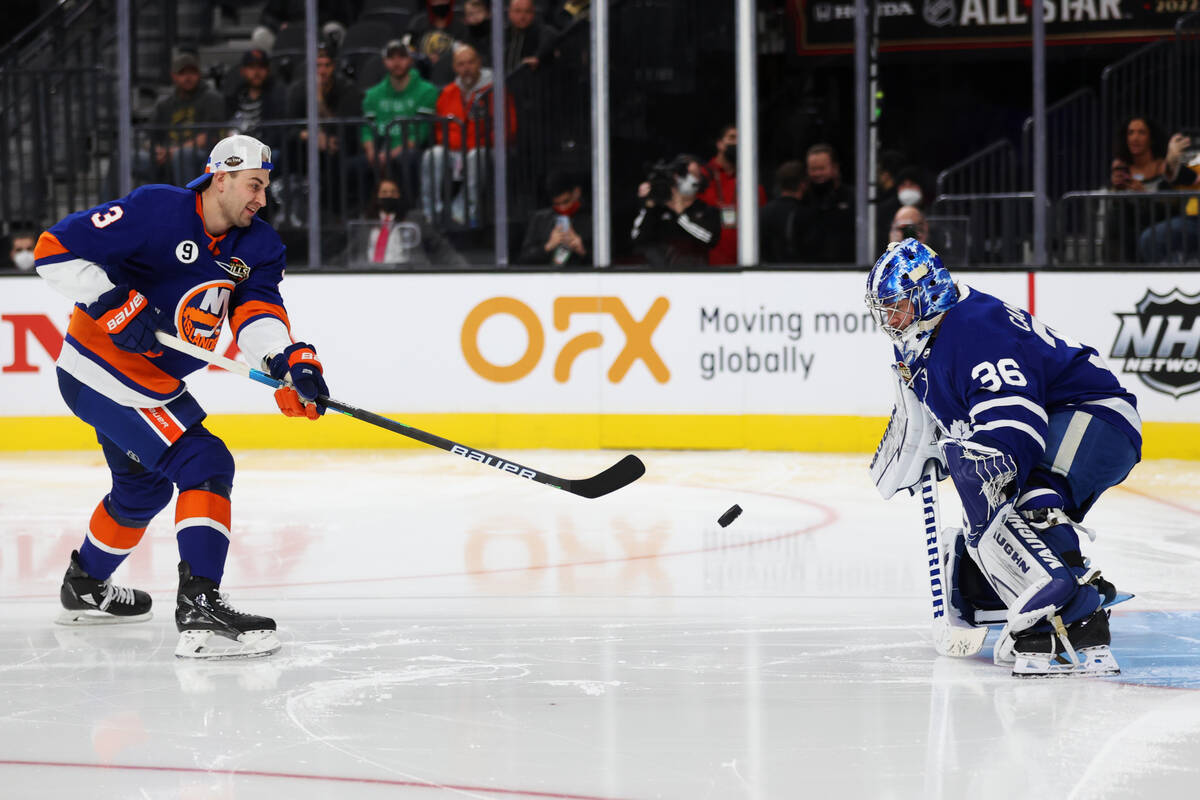 New York Islanders defender Adam Pelech (3) shoots the puck against Toronto Maple Leafs goalkee ...