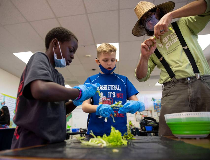 Antrell Montgomery, 9, from left, Ash Krouse, 10, and Joseph Zitello, garden educator for Green ...