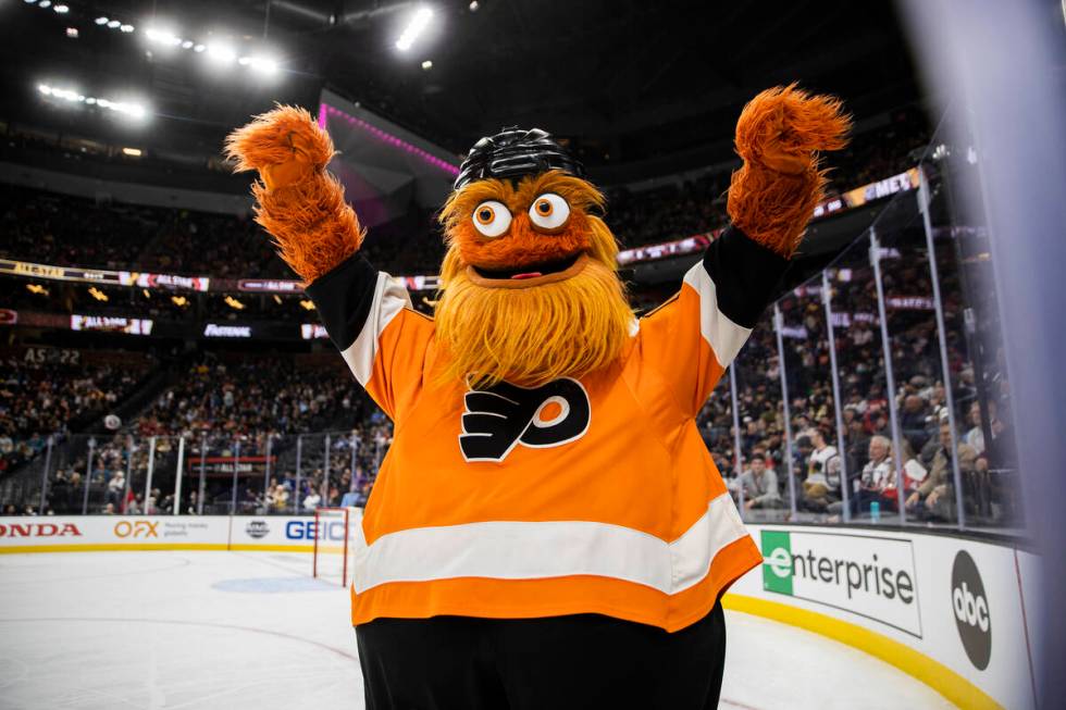 Philadelphia Flyers mascot Gritty waves to fans during the NHL All-Star Game on Saturday, Feb. ...