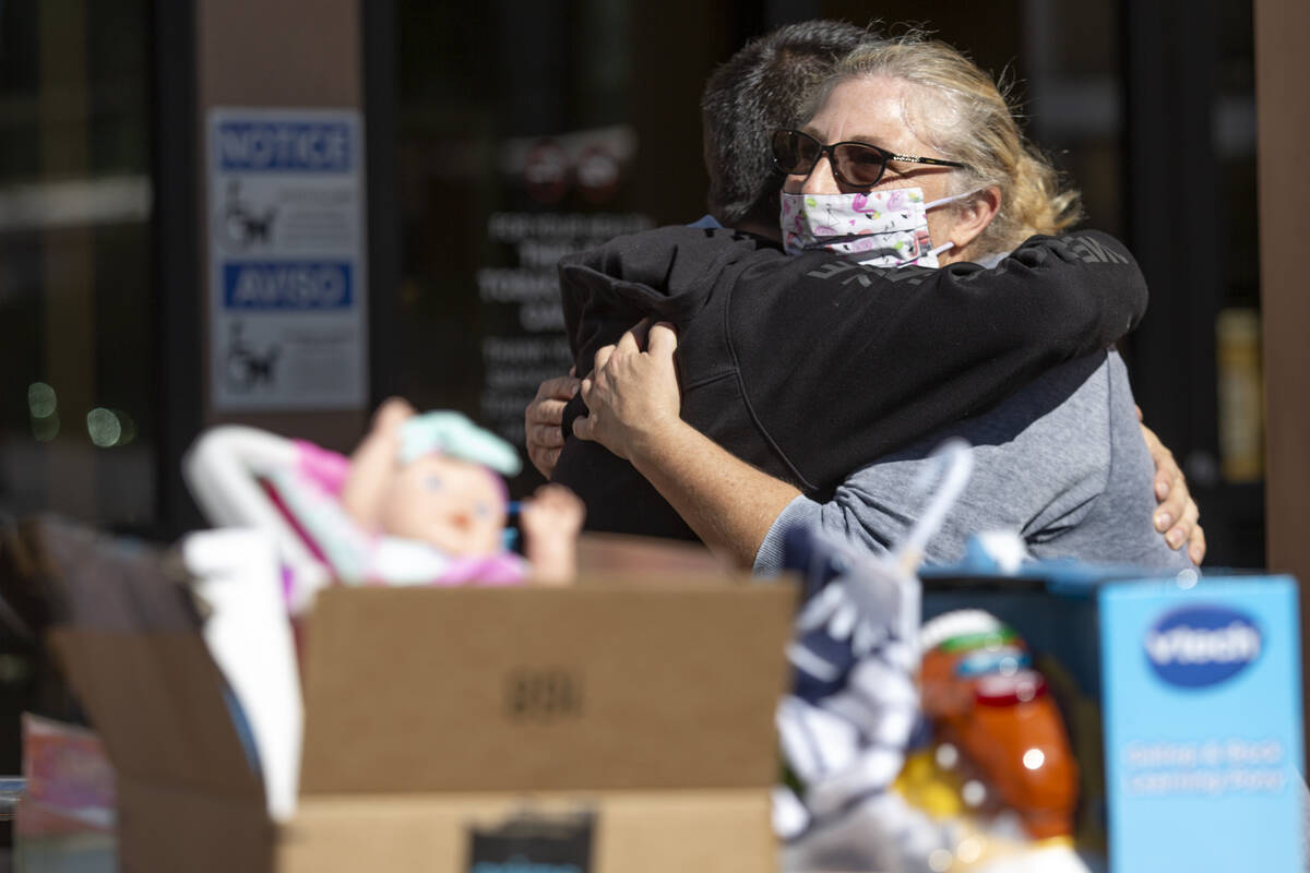 Suzan Smith, mother of Jonny Smith, who died in March 2019 while crossing the street, hugs Chri ...