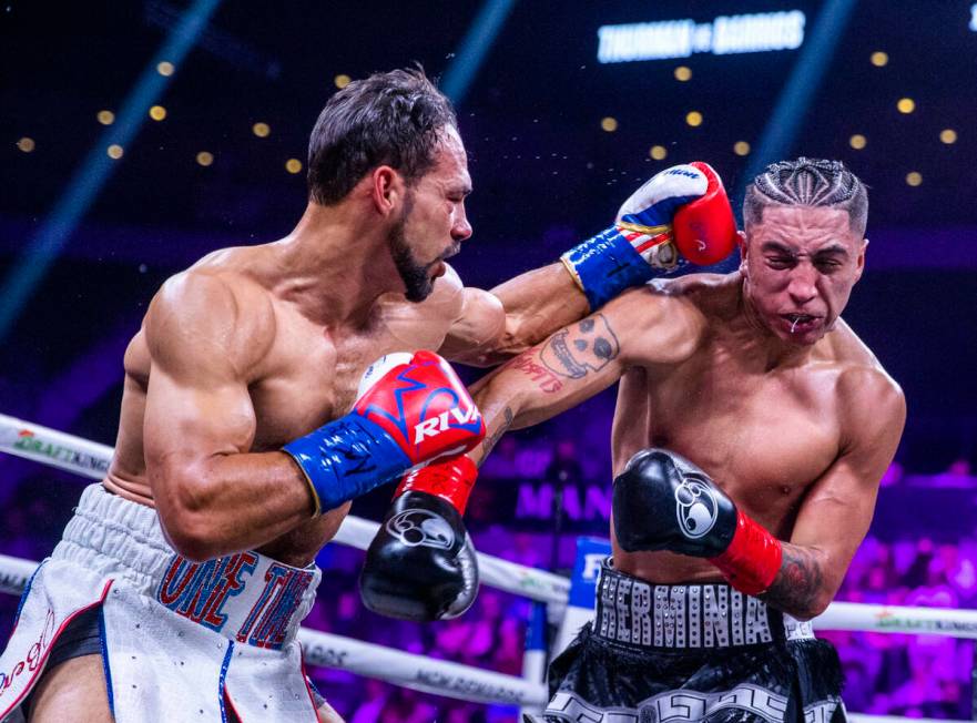 Keith Thurman, left, connects to the head of Mario Barrios during the second round of their Wel ...