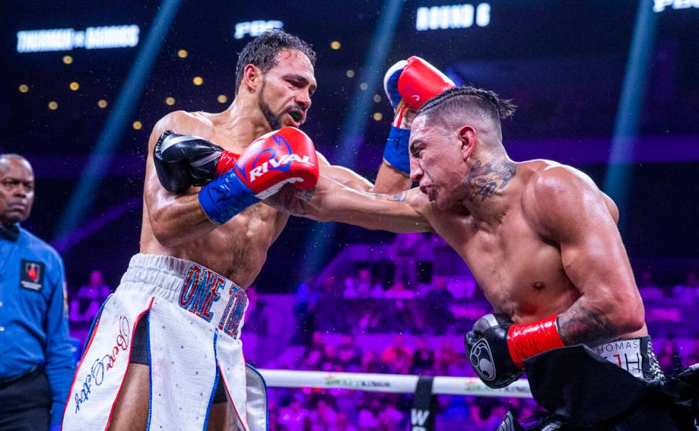 Keith Thurman, left, trades punches with Mario Barrios during the sixth round of their Welterwe ...