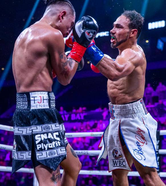 Mario Barrios, left, takes a punch to the face from Keith Thurman during the eighth round of th ...