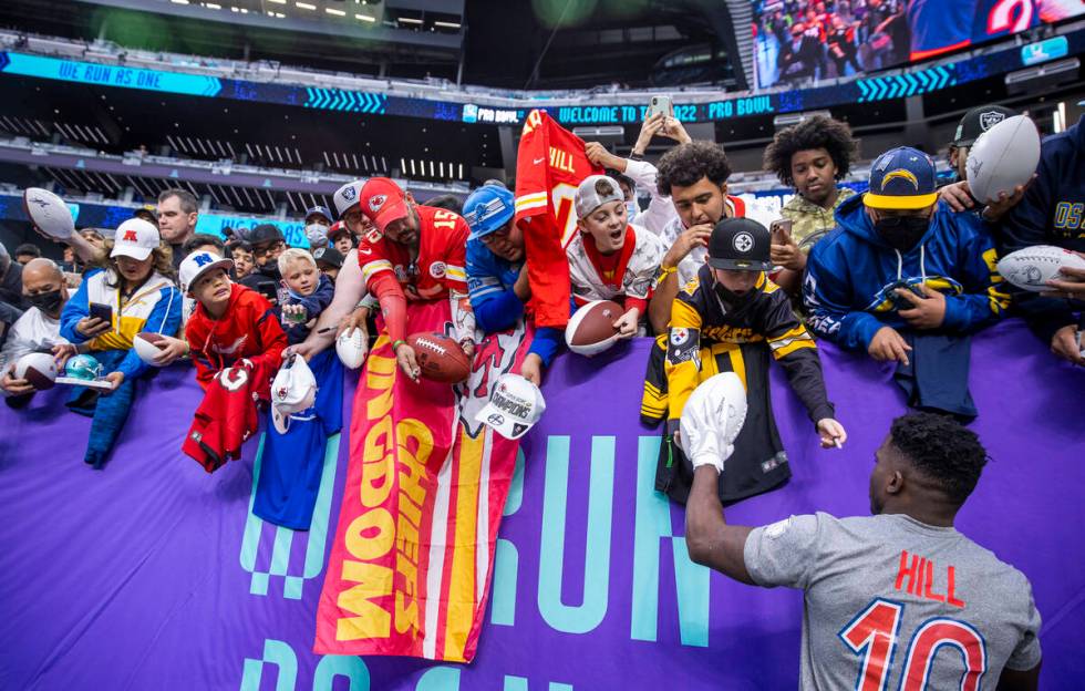 AFC wide receiver Tyreek Hill of the Kansas City Chiefs (10) signs autographs for fans during w ...