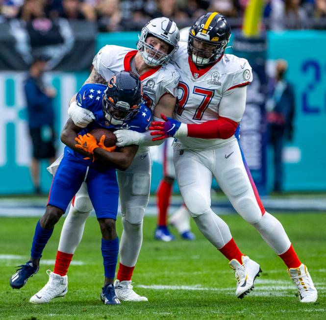 AFC defensive end Maxx Crosby of the Las Vegas Raiders (98) wraps up NFC wide receiver Jakeem G ...