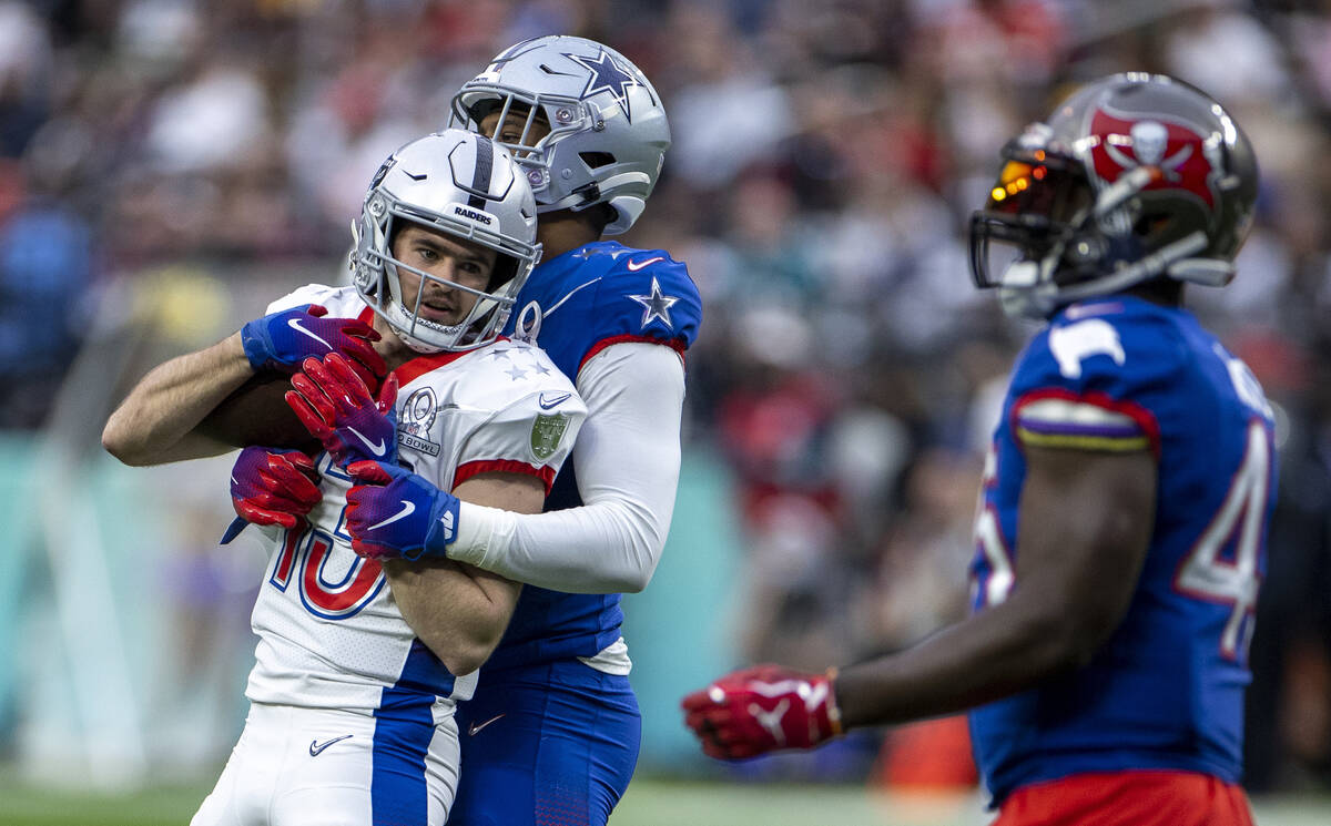 AFC wide receiver Hunter Renfrow of the Las Vegas Raiders (13) is wrapped up by NFC inside line ...