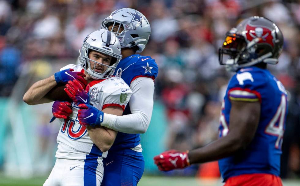 AFC wide receiver Hunter Renfrow of the Las Vegas Raiders (13) is wrapped up by NFC inside line ...