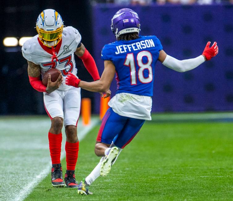 AFC safety Derwin James of the Los Angeles Chargers (33) attempts top stay in bounds after an i ...