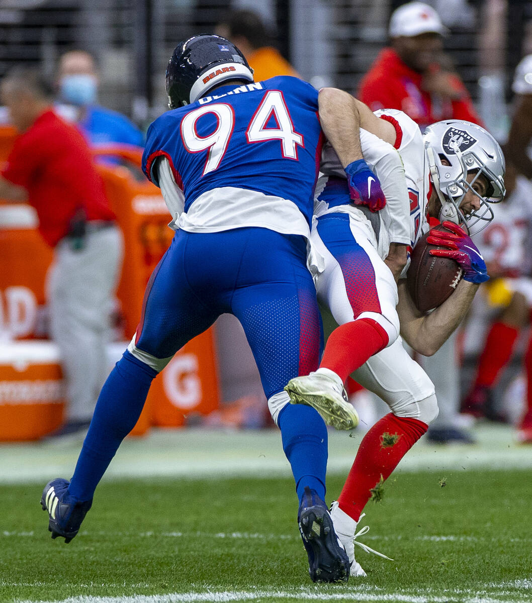 NFC outside linebacker Robert Quinn of the Chicago Bears (94) puts a little hit on AFC wide rec ...