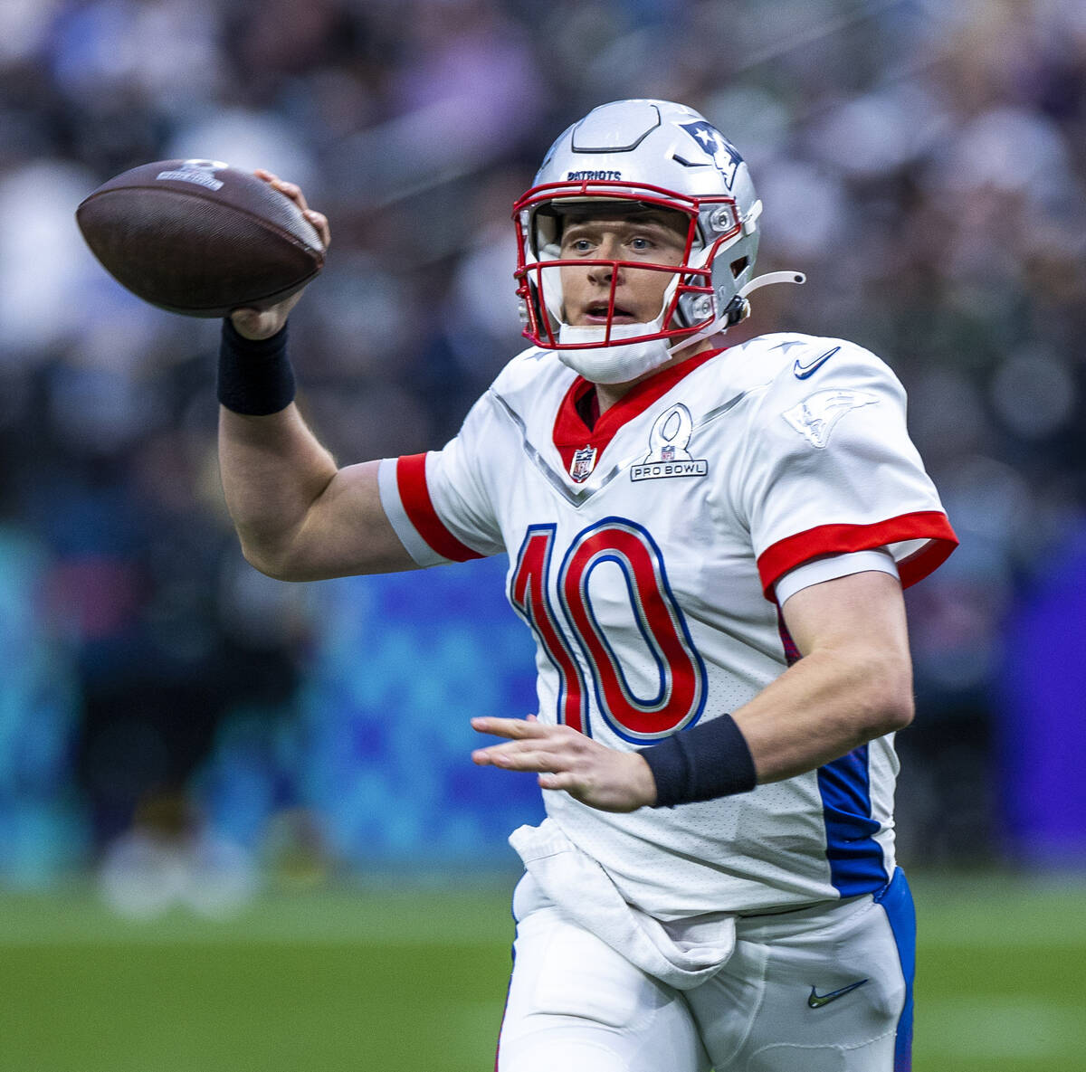 AFC quarterback Mac Jones of the New England Patriots (10) looks for a receiver versus the NFC ...