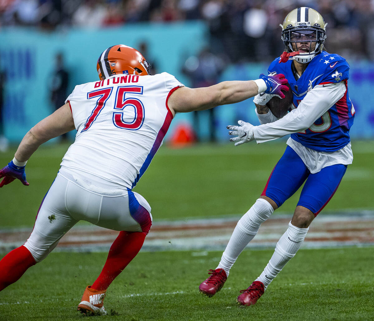 AFC guard Joel Bitonio of the Cleveland Browns (75) attempts to grab the ball from NFC cornerba ...